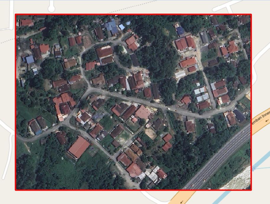 Satellite image of a low-density housing area with a road running through it