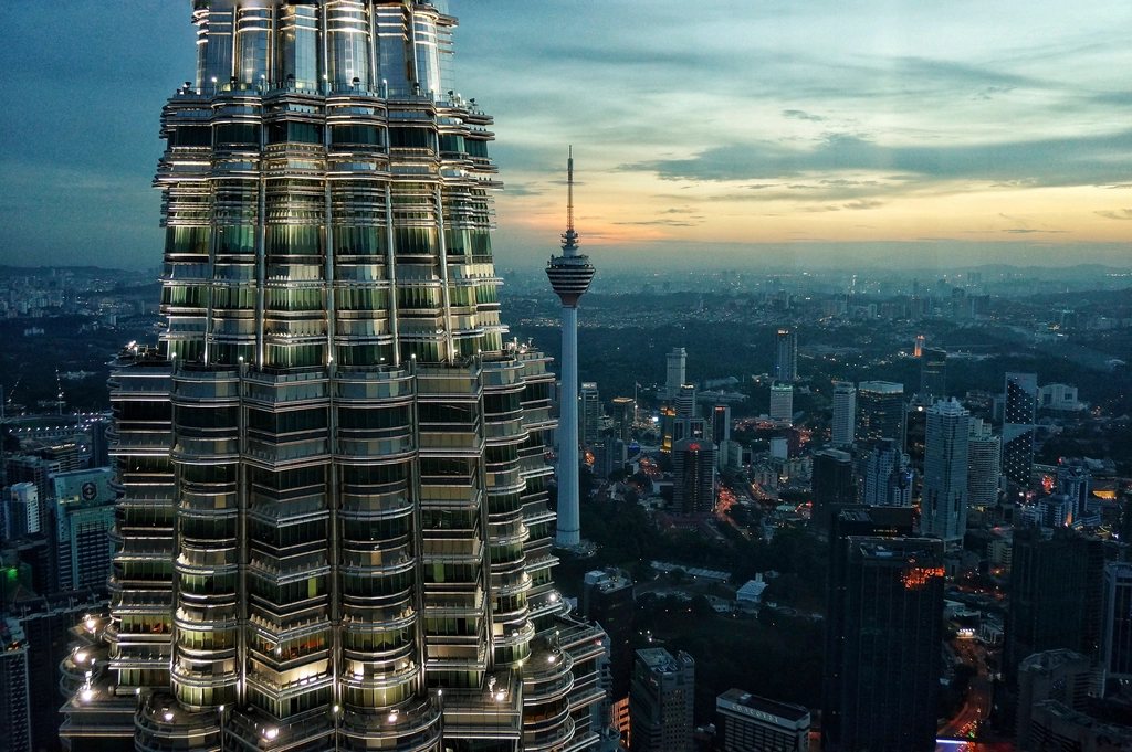 The Petronas Twin Towers and the Kuala Lumpur skyline at dusk